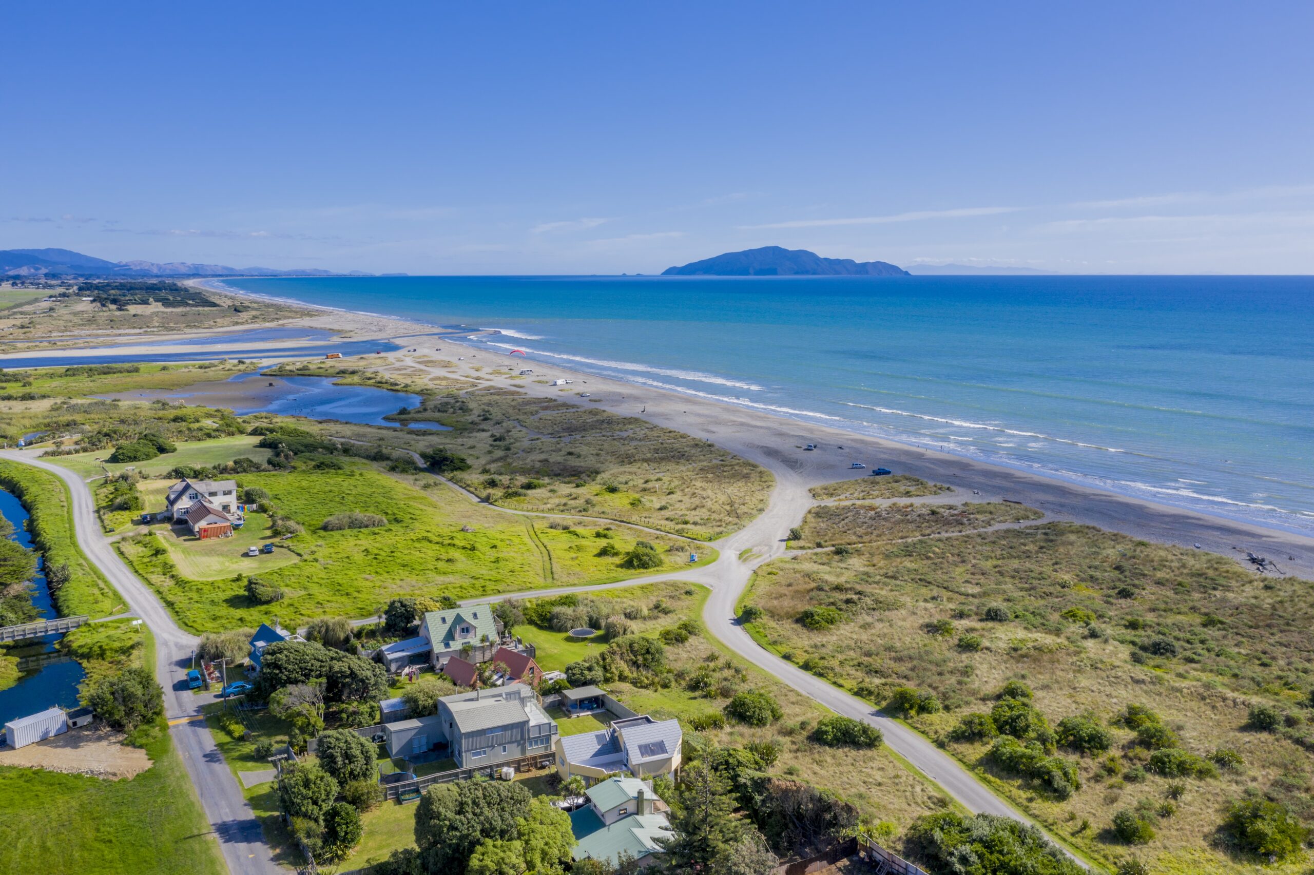 Aerial shot of Otaki Beach in New Zealand showing Kapiti island in the distance
